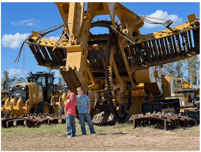 boy in front of heavy machinery